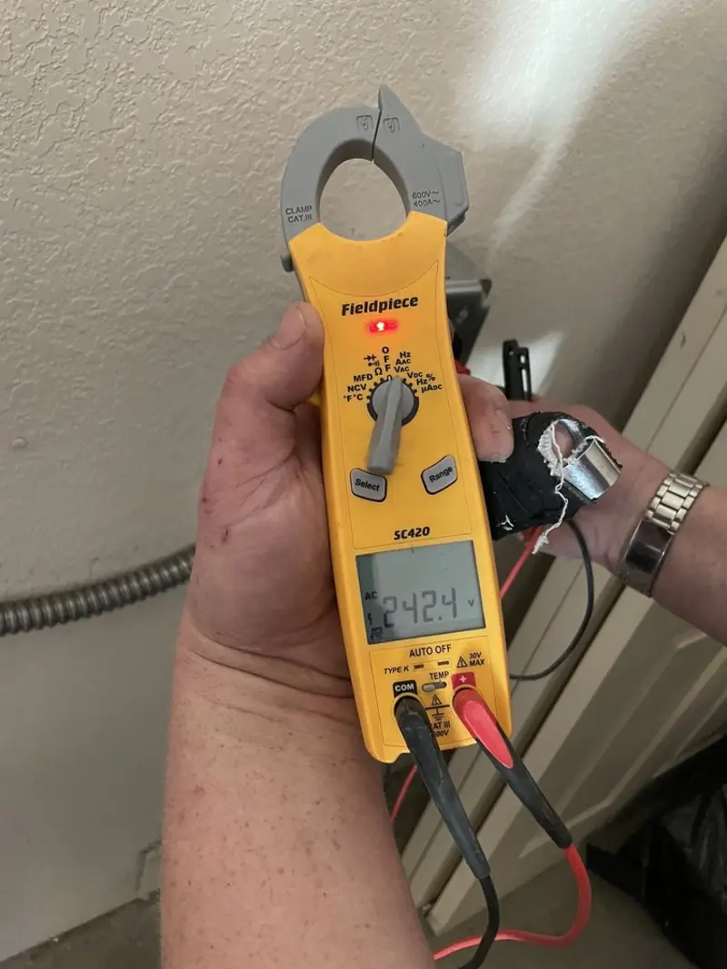 Voltage testing with clamp meter during Recessed Lighting Installation in Macon